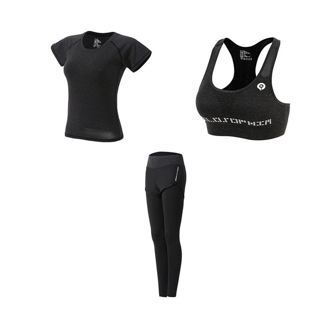 Black athletic outfit with sports bra, t-shirt, and leggings on a white background